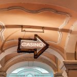 https://unsplash.com/photos/a-casino-sign-hanging-from-the-ceiling-of-a-building-Qjuh9VAkBsg
